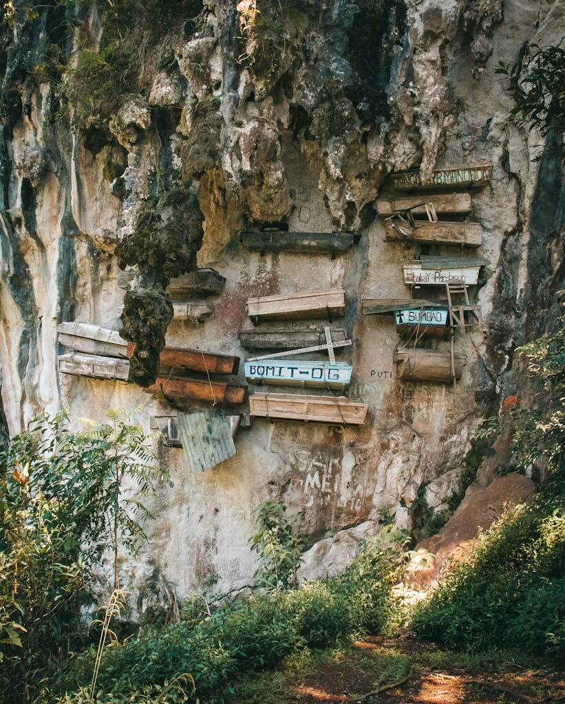 Explore the traditional hanging coffins of Sagada, Philippines, against limestone cliffs. Sagada budget travel and immersion