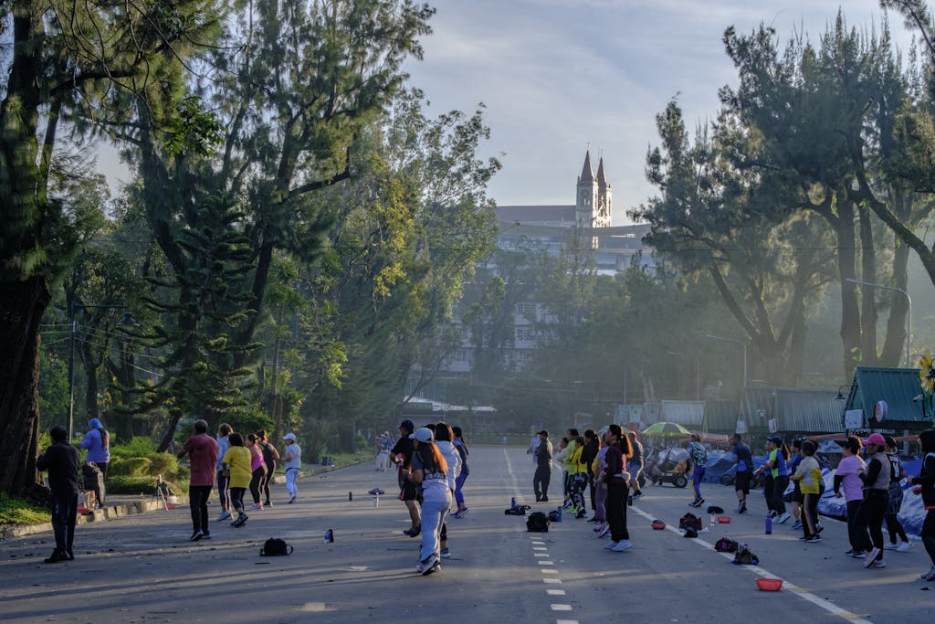 Group of people engaging in outdoor exercise on Baguio's Session Road in the Philippines.