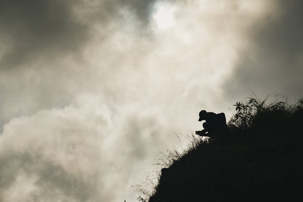 Silhouette of a person on a hillside against dramatic clouds, Bontoc, Philippines. Bontoc Budget Travel and Immersion
