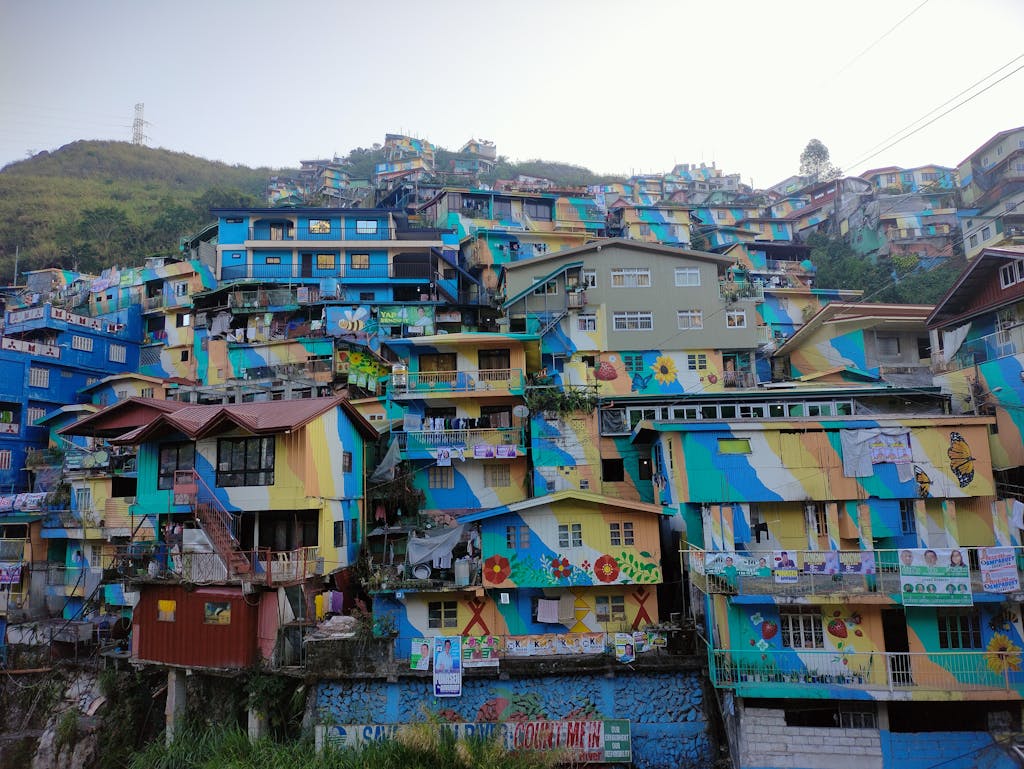 Vibrant mural-painted houses on a hillside in Baguio City Philippines. Baguio City Transit and Infrastructure guide