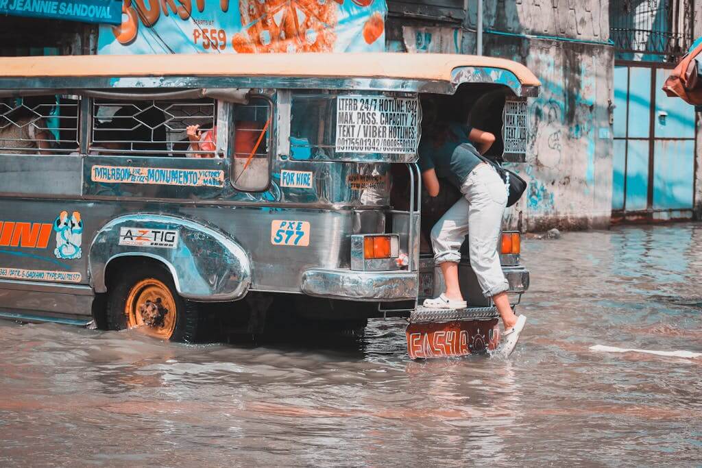 Jeepney navigating through a flooded street in Malabon, Metro Manila during rainy day.