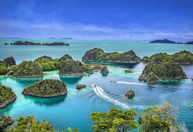 A stunning aerial shot of the lush Raja Ampat Islands in Papua Barat, Indonesia.