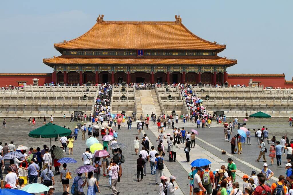 Crowds visiting the historic Forbidden City in Beijing, China trip on a sunny day.