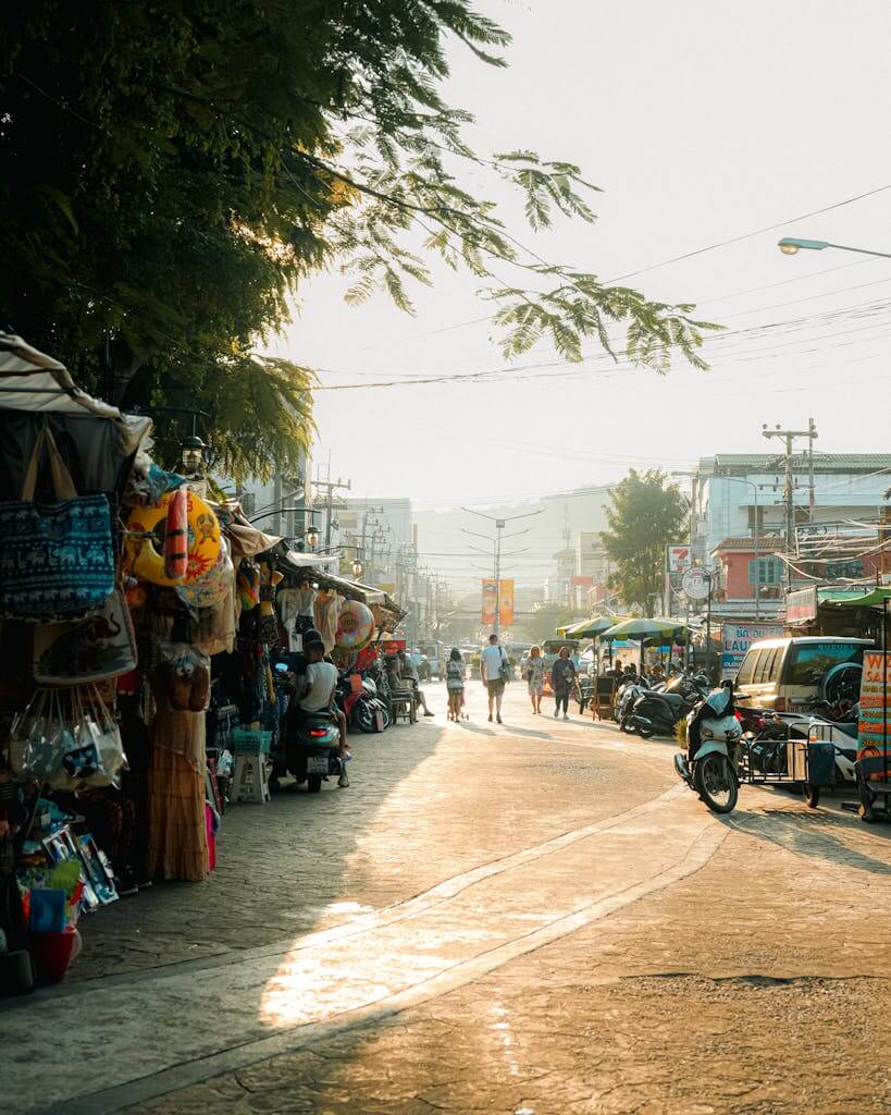 Explore a bustling Thailand street market at sunset, capturing vibrant energy and local culture. Pai Thailand tour