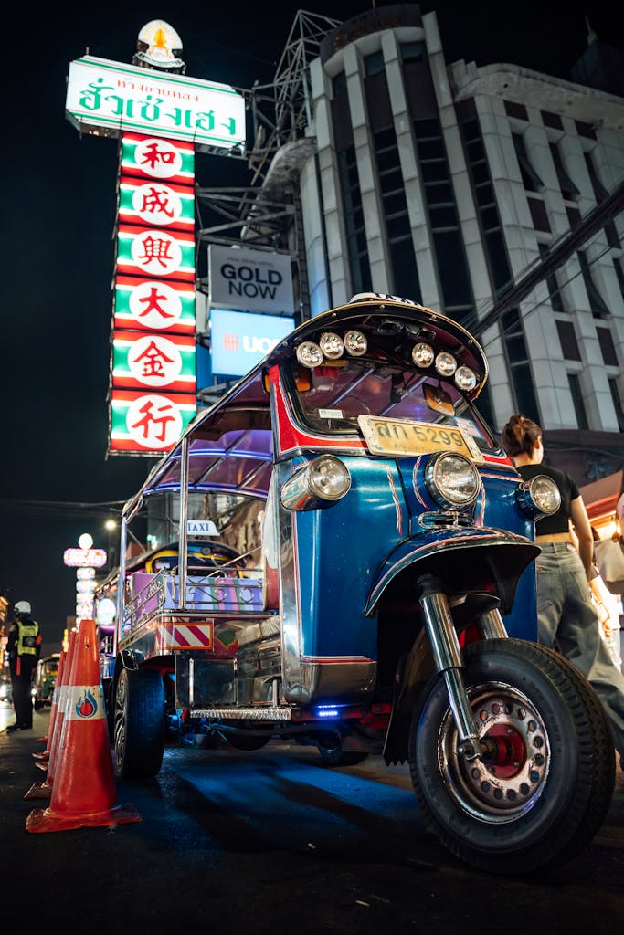 Vibrant night view of a classic tuk-tuk on Bangkok street. Bangkok Thailand Tour