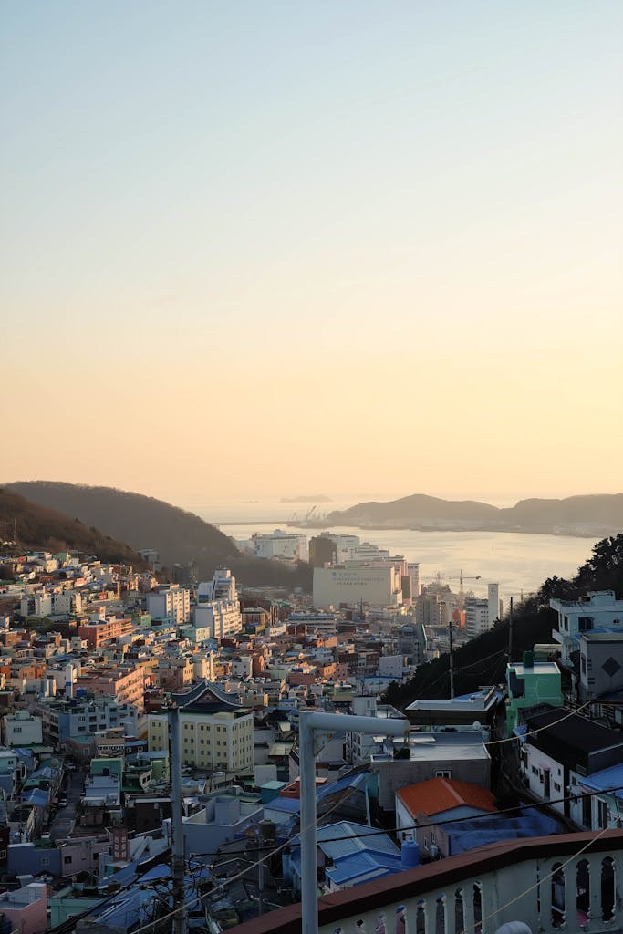 A breathtaking view of the sunset illuminating the vibrant cityscape of Busan, South Korea.