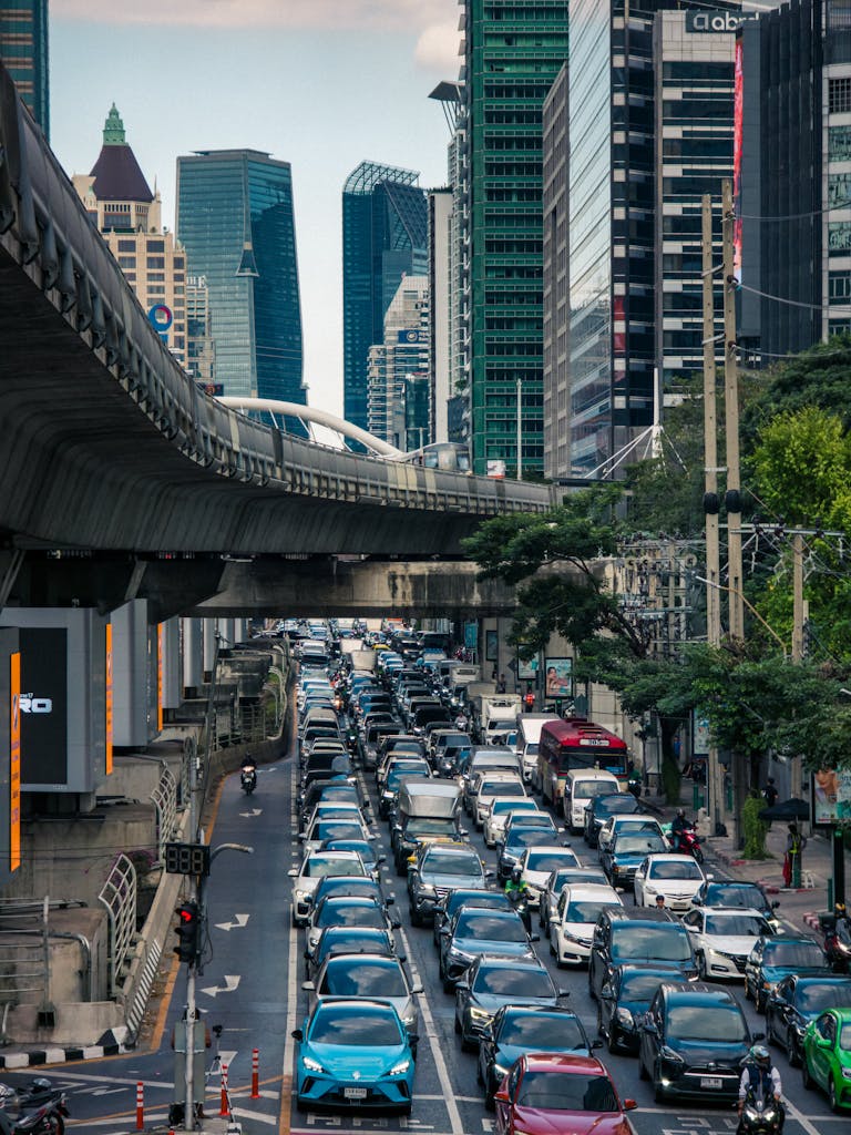 A bustling street scene in Bangkok showcasing skyscrapers and heavy traffic.