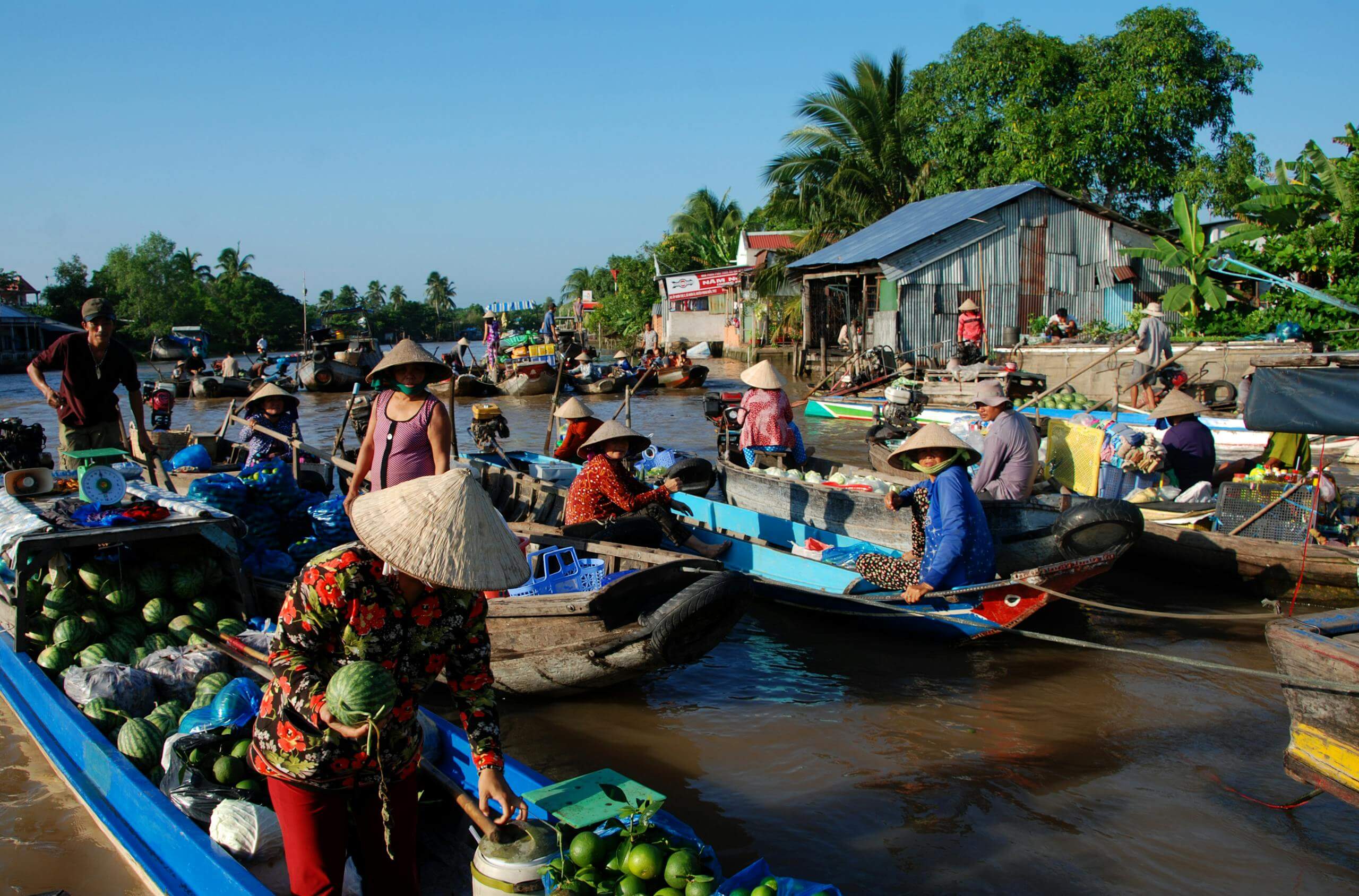 A vibrant scene at a floating market in Ho Chi Minh City, Vietnam, showcasing local culture and commerce.