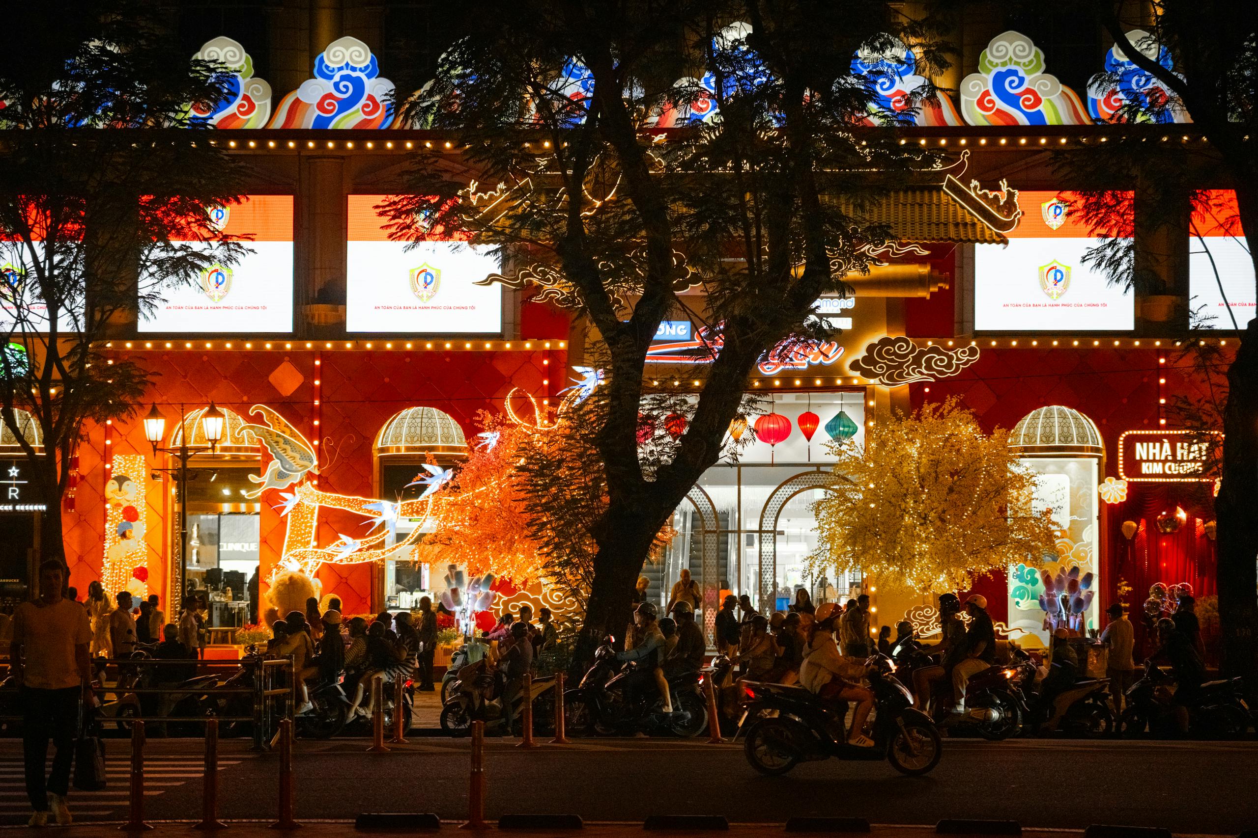 Bustling Ho Chi Minh City nightlife captured in a colorful street scene with neon lights and crowds.