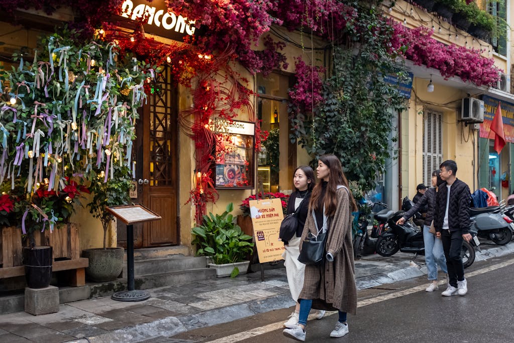Colorful street with pedestrians in Hanoi, Vietnam, showcasing local culture and vibrant atmosphere.
