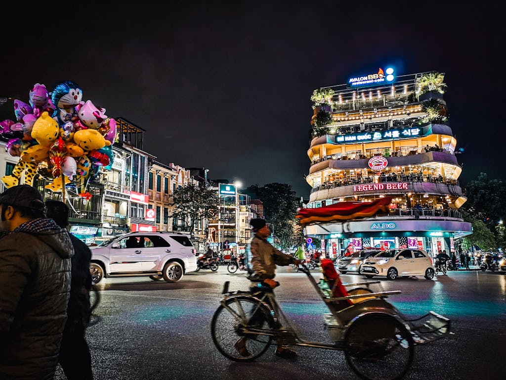 Explore the bustling nightlife of Hanoi with colorful balloons, busy streets, and lively architecture.