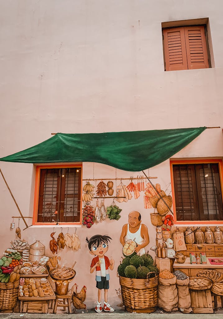 Graffiti of man selling food to boy on wall of grocery shop on town street