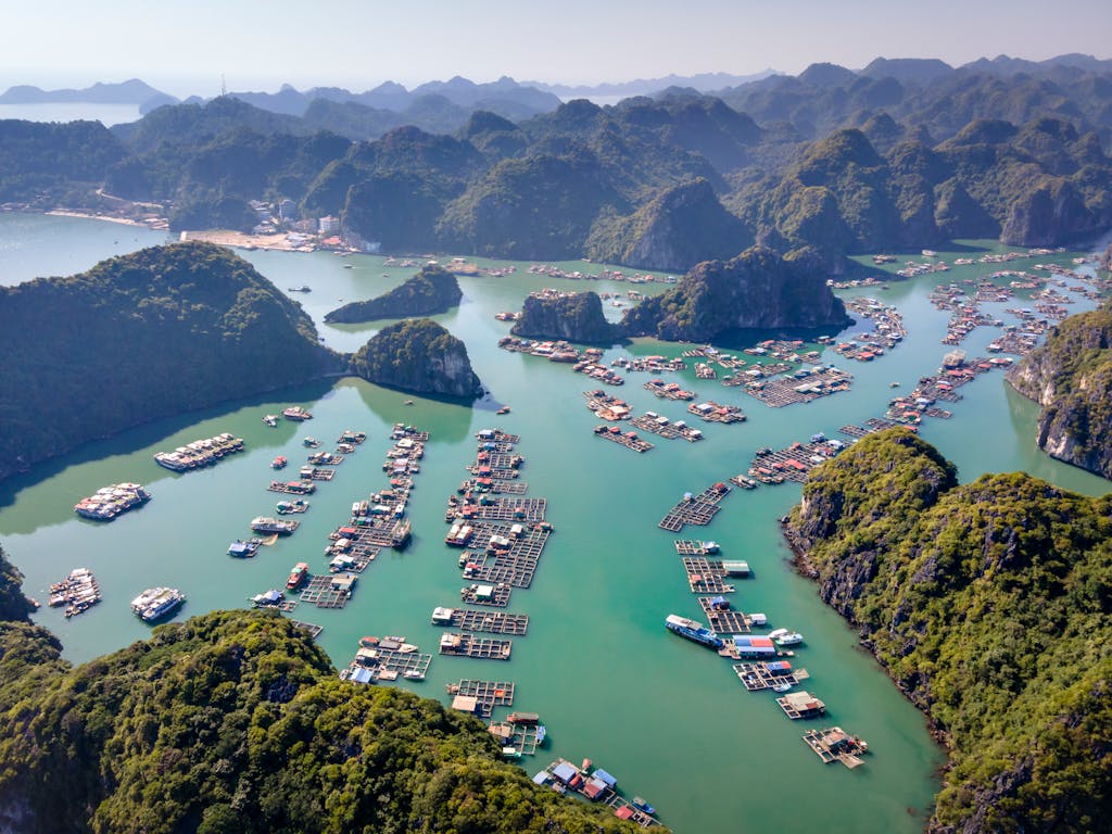 Stunning aerial shot of Ha Long Bay's turquoise waters and floating villages.