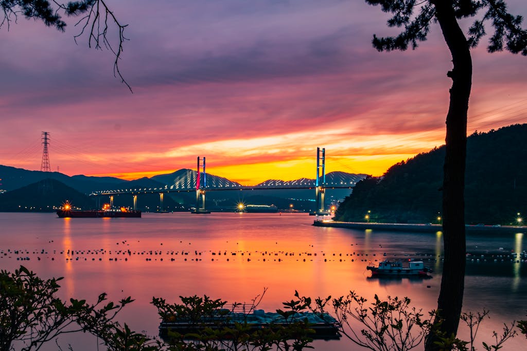 Stunning sunset view over Machangdaegyo Bridge in South Korea with vibrant skies and calm sea.